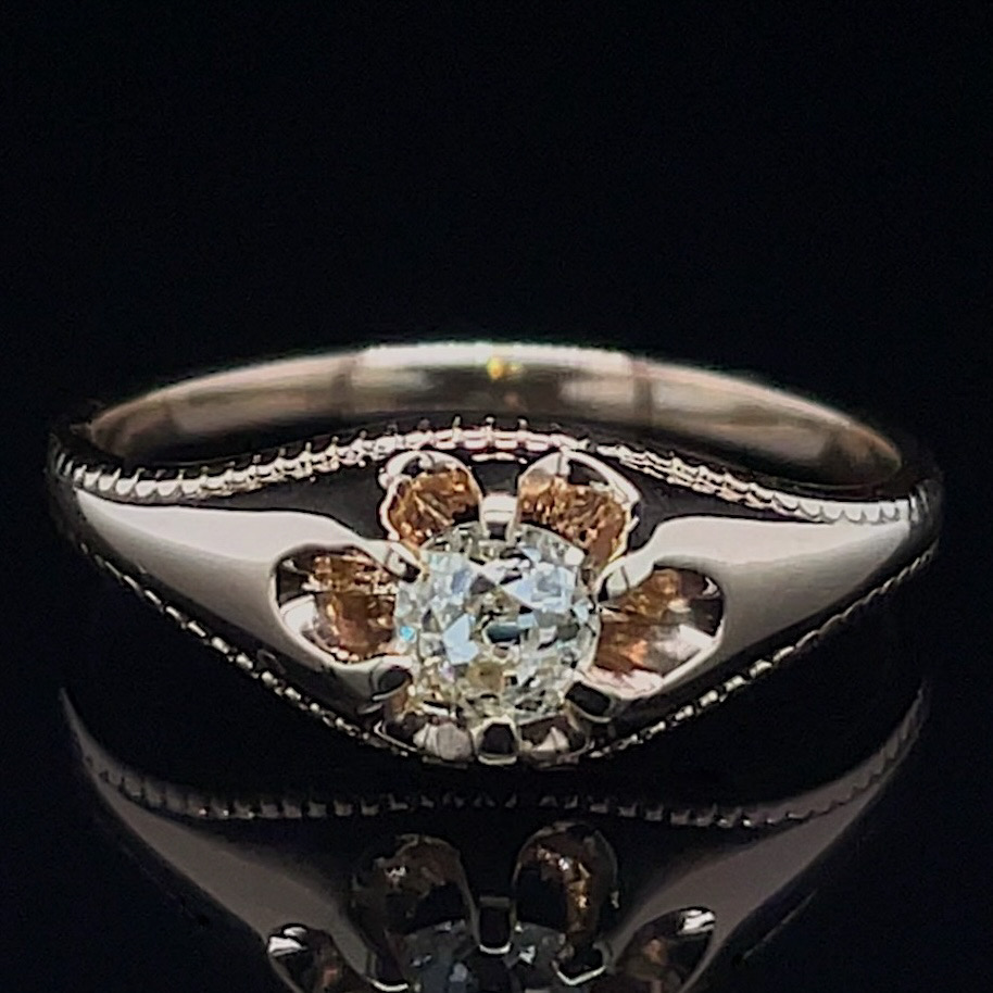 Diamond ring with a central round stone flanked by amber-colored gems in a flower setting on a polished band