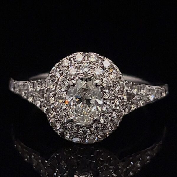 Diamond engagement ring with a central round stone surrounded by a halo of smaller diamonds on a black background.