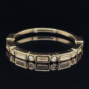 Gold-tone bracelet with rectangular and circular gemstone settings on a black background.