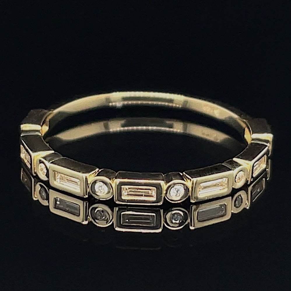Gold-tone bracelet with rectangular and circular gemstone settings on a black background.
